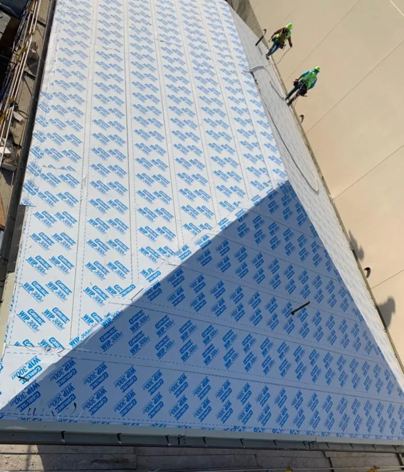 Professional roofers installing underlayment on a metal roof in Sunbury